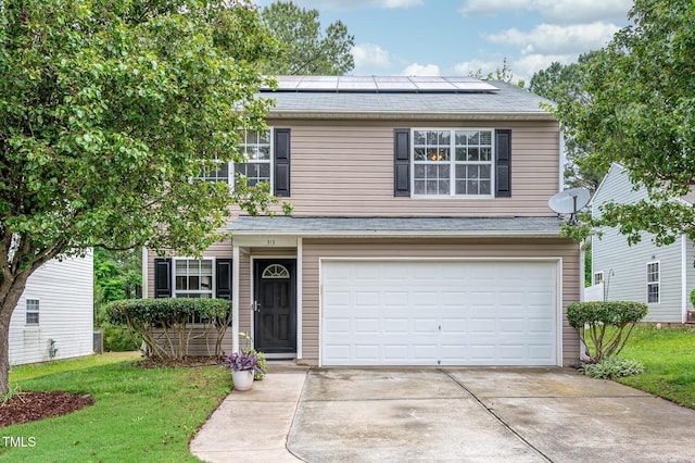 313 Weeping Willow Dr, Durham, NC 27704 - traditional-style house with an attached garage, solar panels, driveway, and a front yard