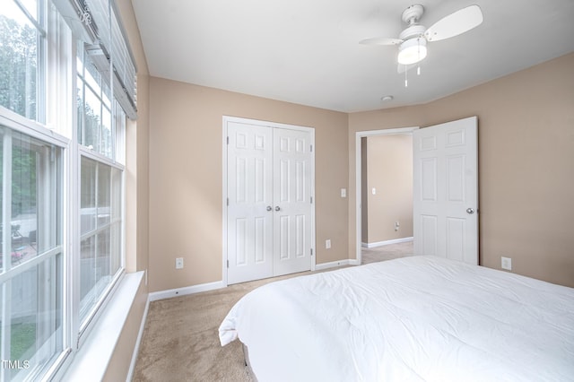 313 Weeping Willow Dr, Durham, NC 27704 - bedroom with light colored carpet, baseboards, a closet, and a ceiling fan