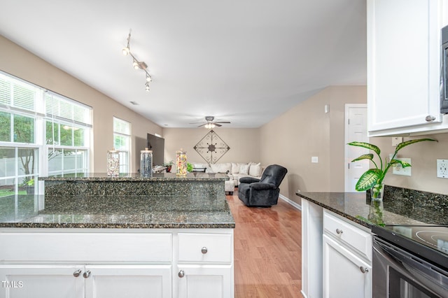 313 Weeping Willow Dr, Durham, NC 27704 - kitchen featuring white cabinetry, ceiling fan, light wood-style flooring, and dark stone countertops