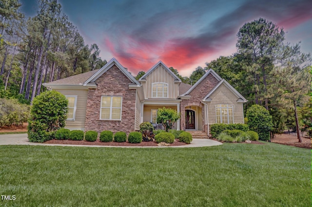 216 Colonial Ridge Dr, Pittsboro, NC 27312 - craftsman-style house with a yard, stone siding, and board and batten siding