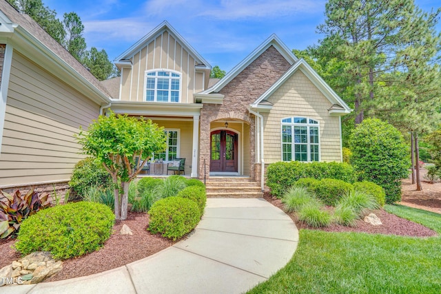 216 Colonial Ridge Dr, Pittsboro, NC 27312 - doorway to property with covered porch, french doors, and a shingled roof