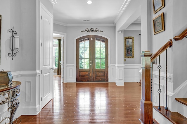 216 Colonial Ridge Dr, Pittsboro, NC 27312 - foyer entrance featuring wainscoting, stairs, wood-type flooring, a decorative wall, and ornamental molding
