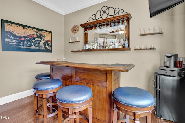 216 Colonial Ridge Dr, Pittsboro, NC 27312 - indoor dry bar featuring wood finished floors, crown molding, and baseboards