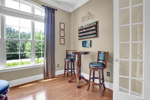 216 Colonial Ridge Dr, Pittsboro, NC 27312 - living area with ornamental molding, baseboards, plenty of natural light, wood finished floors, and a dry bar