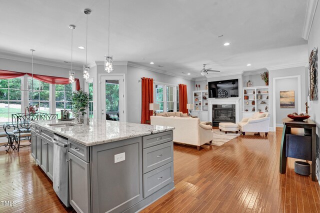 216 Colonial Ridge Dr, Pittsboro, NC 27312 - kitchen featuring gray cabinetry, a ceiling fan, a sink, a glass covered fireplace, and recessed lighting