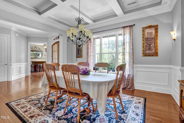 216 Colonial Ridge Dr, Pittsboro, NC 27312 - dining space featuring a chandelier, hardwood / wood-style floors, beam ceiling, crown molding, and a wainscoted wall