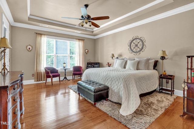 216 Colonial Ridge Dr, Pittsboro, NC 27312 - bedroom featuring a tray ceiling, ornamental molding, light wood-style flooring, baseboards, and ceiling fan
