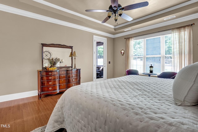 216 Colonial Ridge Dr, Pittsboro, NC 27312 - bedroom featuring a raised ceiling, baseboards, crown molding, wood finished floors, and ceiling fan