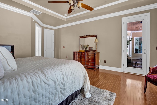 216 Colonial Ridge Dr, Pittsboro, NC 27312 - bedroom featuring hardwood / wood-style floors, crown molding, a raised ceiling, ceiling fan, and baseboards