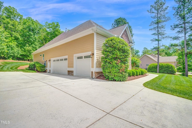 216 Colonial Ridge Dr, Pittsboro, NC 27312 - view of property exterior featuring concrete driveway, a garage, a yard, and stone siding