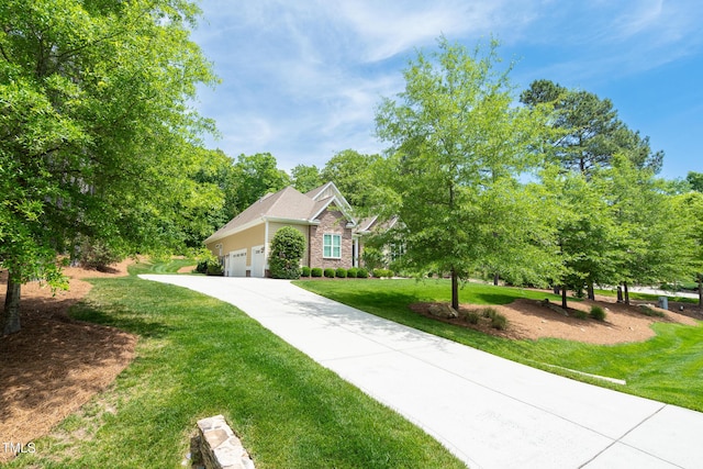 216 Colonial Ridge Dr, Pittsboro, NC 27312 - view of front of house featuring a front lawn, driveway, and a garage