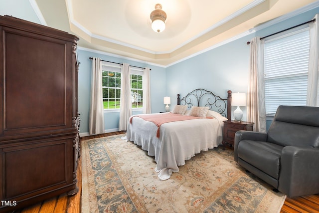 3916 Rustic Mill Dr, Apex, NC 27539 - bedroom with a tray ceiling, wood finished floors, and crown molding