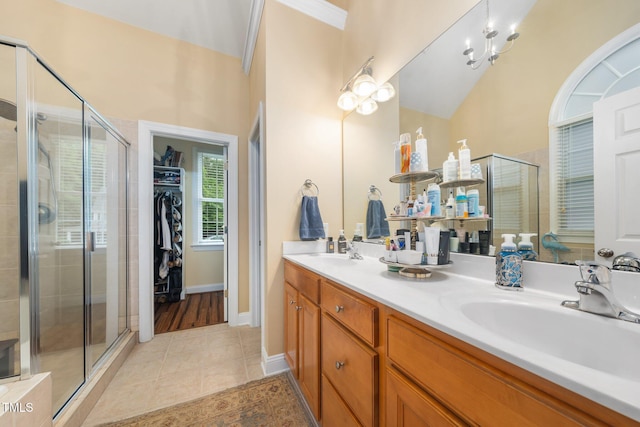3916 Rustic Mill Dr, Apex, NC 27539 - full bathroom with double vanity, a stall shower, tile patterned floors, a spacious closet, and baseboards