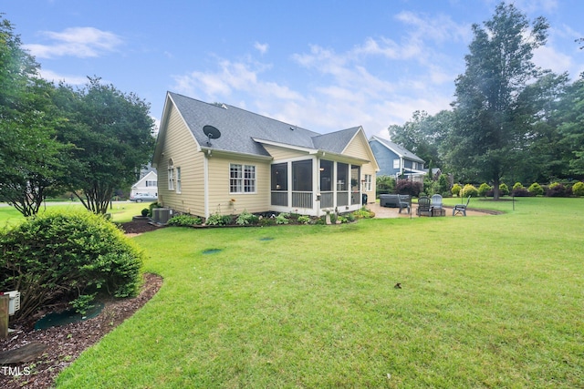 3916 Rustic Mill Dr, Apex, NC 27539 - rear view of property featuring a sunroom, a patio, a yard, and roof with shingles