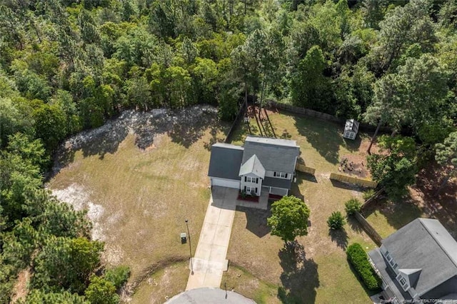 view of property location featuring a forest