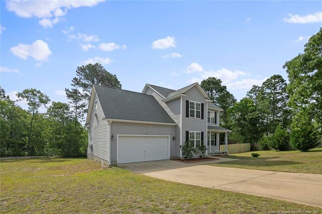 traditional-style house with concrete driveway, a front lawn, an attached garage, and covered porch