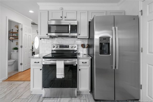 kitchen featuring appliances with stainless steel finishes, crown molding, light stone countertops, tasteful backsplash, and recessed lighting