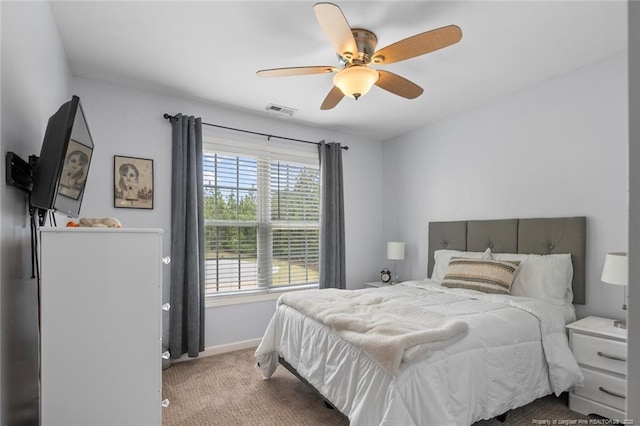 carpeted bedroom featuring baseboards and ceiling fan