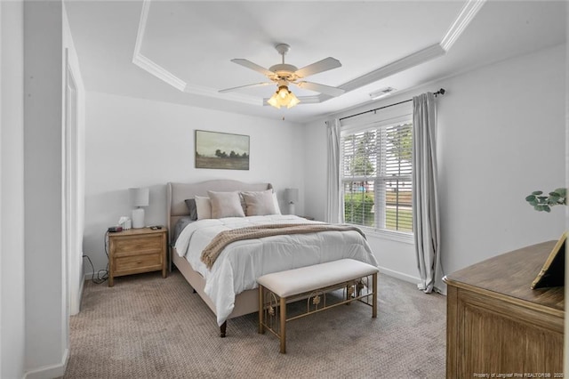 bedroom featuring a raised ceiling, light carpet, crown molding, baseboards, and ceiling fan