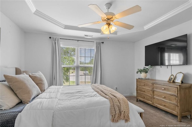 bedroom featuring a raised ceiling, carpet, ornamental molding, ceiling fan, and baseboards