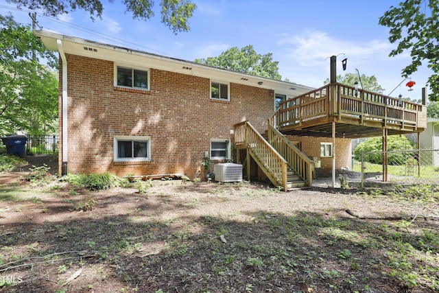 712 Beaver Dam Rd, Raleigh, NC 27607 - rear view of property featuring central air condition unit, a wooden deck, fence, stairs, and brick siding