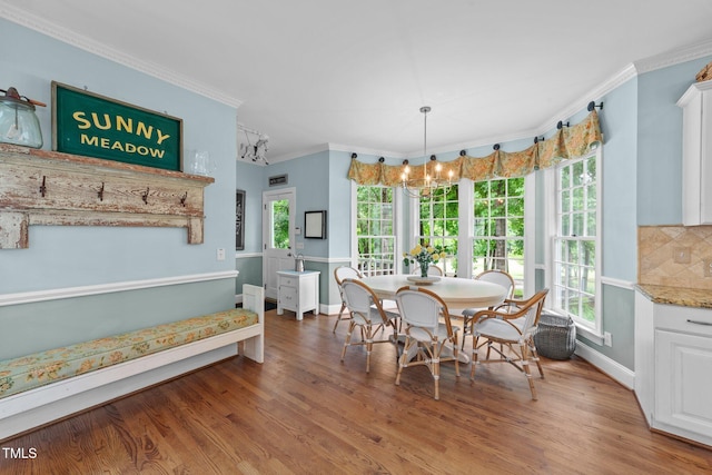 5308 Stableview Ct, Holly Springs, NC 27540 - dining area featuring a chandelier, wood finished floors, and crown molding