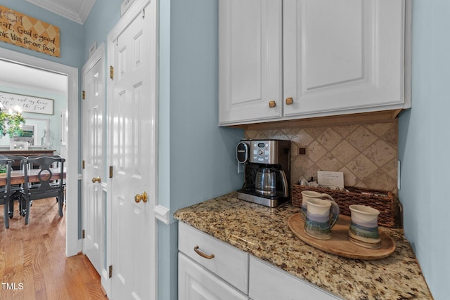 5308 Stableview Ct, Holly Springs, NC 27540 - bar with backsplash, crown molding, and light wood-type flooring