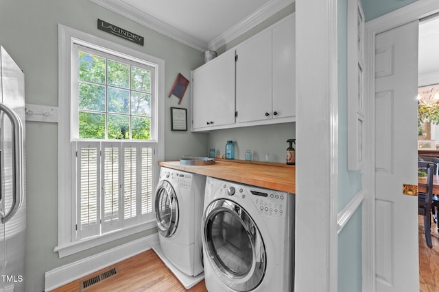 5308 Stableview Ct, Holly Springs, NC 27540 - washroom with washer and dryer, cabinet space, light wood-type flooring, and crown molding
