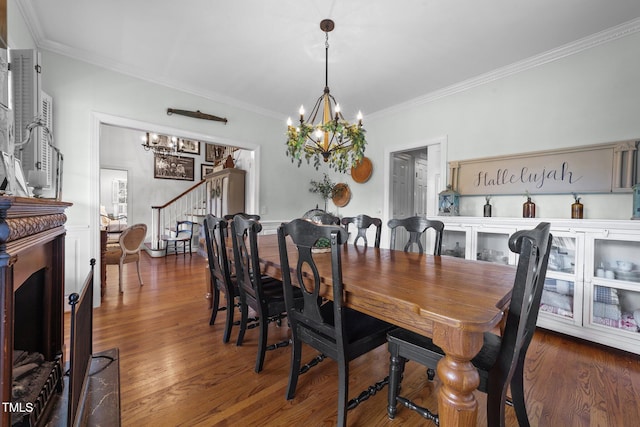 5308 Stableview Ct, Holly Springs, NC 27540 - dining space featuring a chandelier, stairs, crown molding, wood finished floors, and a fireplace