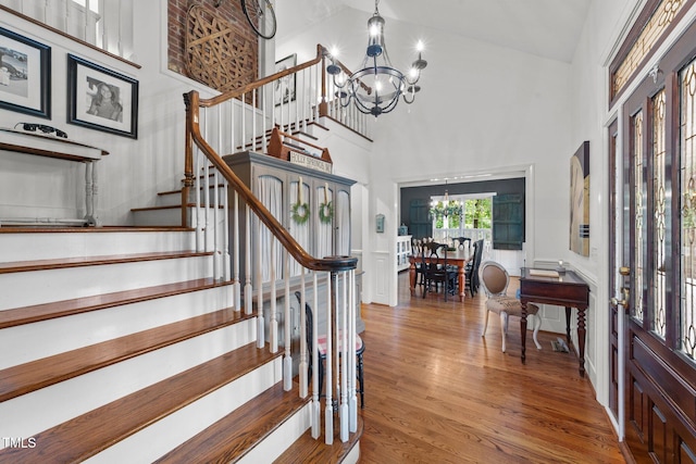 5308 Stableview Ct, Holly Springs, NC 27540 - entrance foyer featuring a chandelier, a towering ceiling, stairs, and wood finished floors