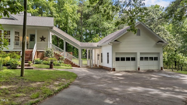 5308 Stableview Ct, Holly Springs, NC 27540 - single story home with asphalt driveway, roof with shingles, an attached garage, stairway, and a porch