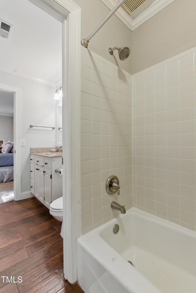 5308 Stableview Ct, Holly Springs, NC 27540 - full bathroom featuring crown molding, vanity, shower / bath combination, wood finished floors, and ensuite bathroom