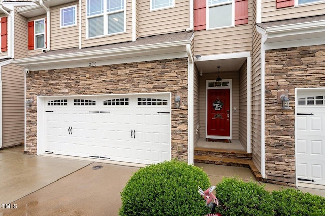270 Wembley Dr, Clayton, NC 27527 - entrance to property featuring stone siding, a garage, and driveway