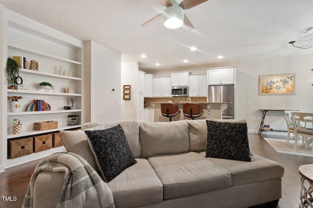 270 Wembley Dr, Clayton, NC 27527 - living area with ceiling fan, dark wood finished floors, recessed lighting, baseboards, and built in shelves