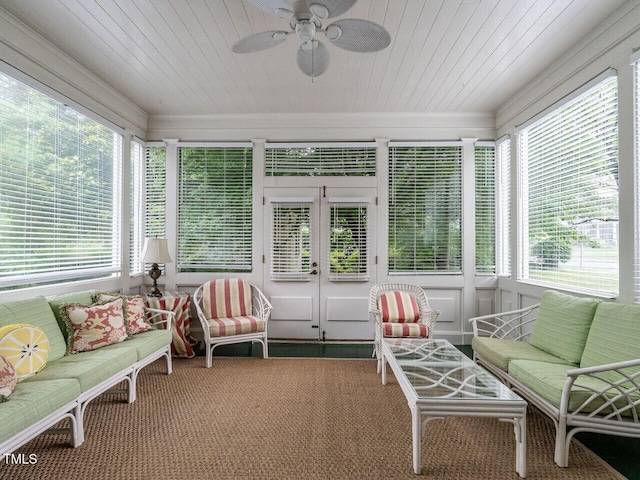 sunroom / solarium featuring wood ceiling, ceiling fan, carpet flooring, an outdoor living space, and crown molding