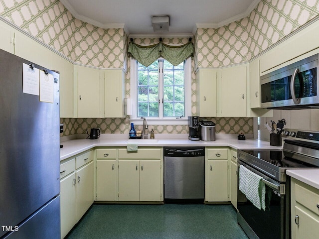 kitchen with stainless steel appliances, a sink, crown molding, light countertops, and tasteful backsplash