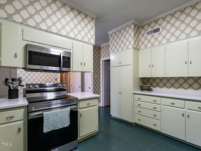 kitchen with stainless steel microwave, electric range, crown molding, light countertops, and wallpapered walls