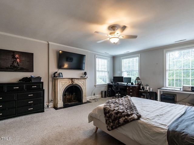 bedroom with ornamental molding, carpet, a fireplace with flush hearth, a ceiling fan, and baseboards