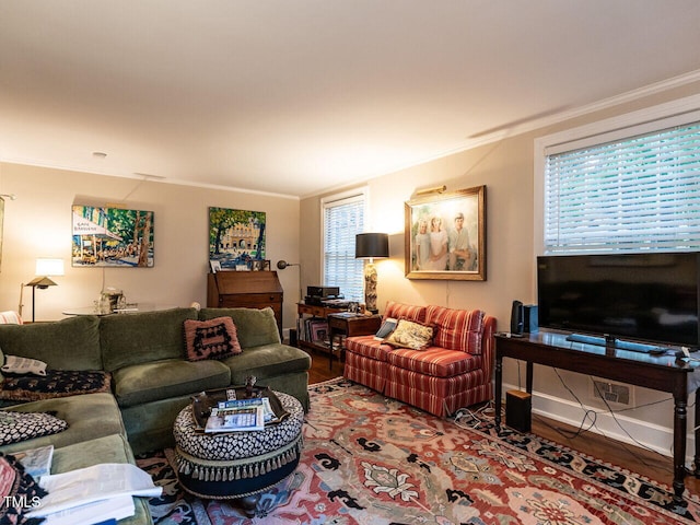 living area with ornamental molding and wood finished floors