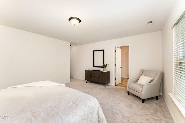 bedroom with light carpet and baseboards