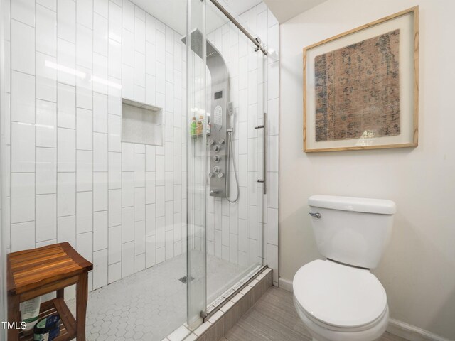 7605 Copper Mine Ln, Raleigh, NC 27615 - full bathroom with a stall shower, toilet, and baseboards