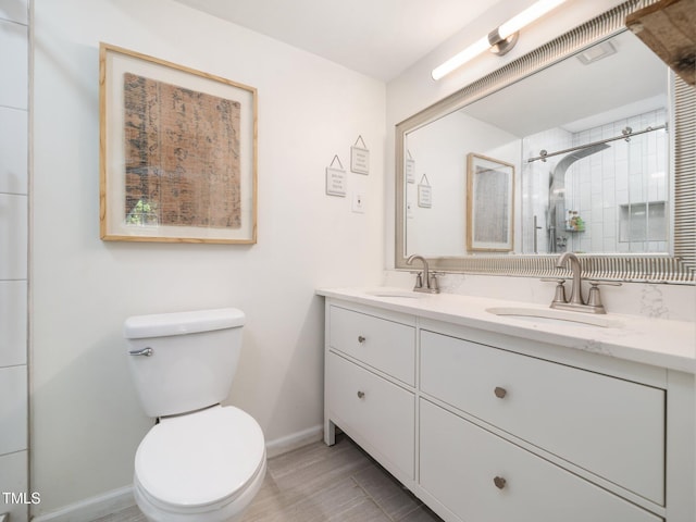 7605 Copper Mine Ln, Raleigh, NC 27615 - full bathroom featuring double vanity, baseboards, toilet, and tiled shower