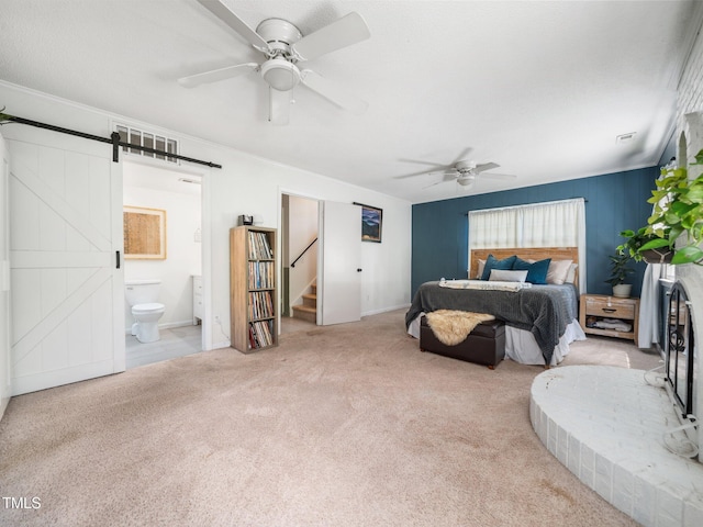 7605 Copper Mine Ln, Raleigh, NC 27615 - carpeted bedroom featuring a barn door, ensuite bath, and a ceiling fan