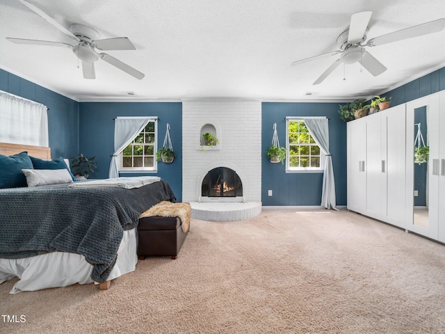 7605 Copper Mine Ln, Raleigh, NC 27615 - bedroom featuring carpet, a textured ceiling, a fireplace, ceiling fan, and wooden walls