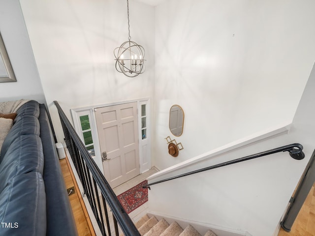 7605 Copper Mine Ln, Raleigh, NC 27615 - foyer entrance with a chandelier, light wood-type flooring, and stairs