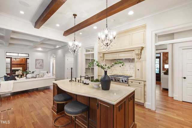 131 Lavinia Ln, Chapel Hill, NC 27516 - kitchen with cream cabinetry, a chandelier, decorative backsplash, open floor plan, and beamed ceiling