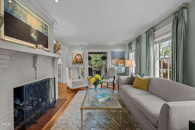 1015 Watts St, Durham, NC 27701 - living room featuring wood finished floors, ornamental molding, a brick fireplace, and recessed lighting