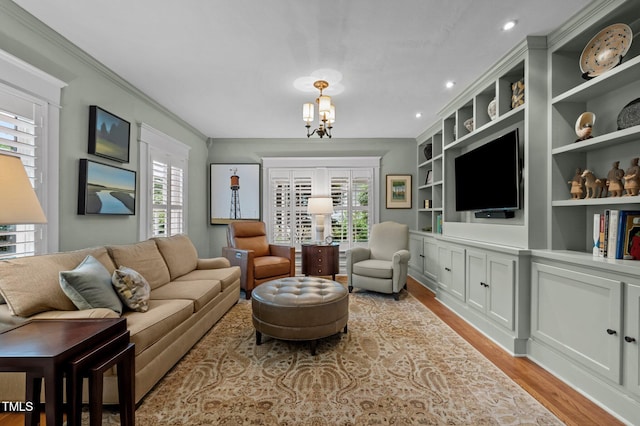 1015 Watts St, Durham, NC 27701 - living area featuring light wood finished floors, a chandelier, crown molding, built in shelves, and recessed lighting
