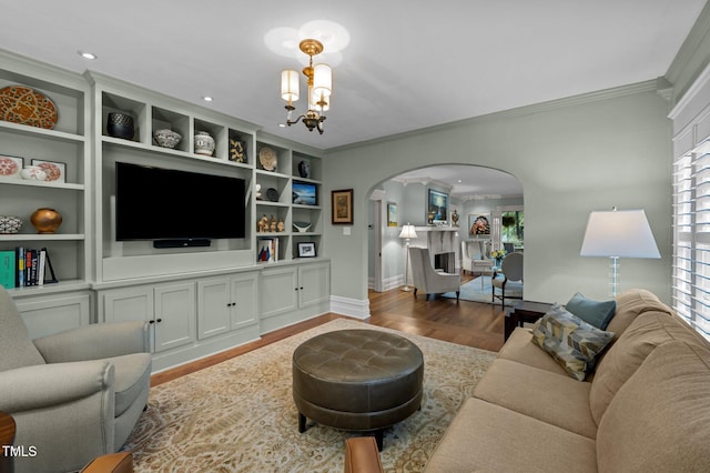 1015 Watts St, Durham, NC 27701 - living area featuring arched walkways, crown molding, baseboards, wood finished floors, and a chandelier