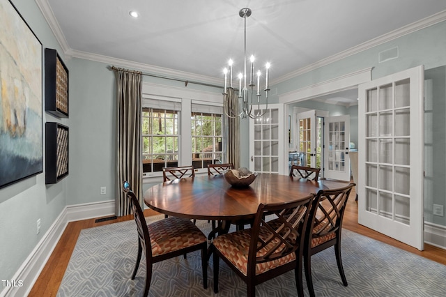 1015 Watts St, Durham, NC 27701 - dining area with a chandelier, french doors, wood finished floors, baseboards, and ornamental molding